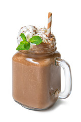 Vanilla chocolate milkshake with whipped cream and mint in glass jar isolated on white background
