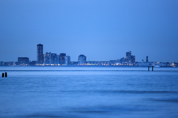 The skyline of Vlissingen and the estuary of the Scheldt river after sunset