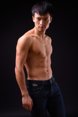 Fototapeta premium Portrait of young muscular Asian man shirtless