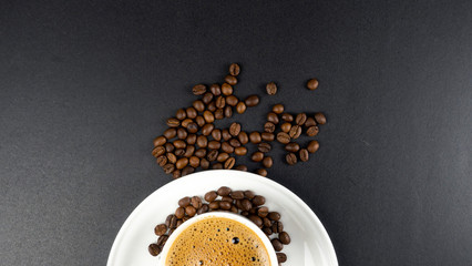 coffee love, coffee beans, latte art with bubbles in a black cup on a black background