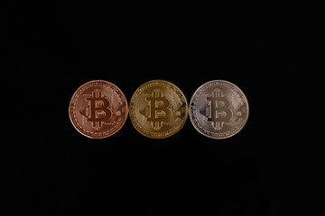 Close up of a line of coins with symbol B isolated on black background