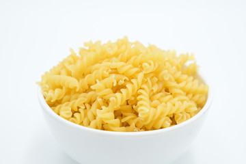 Twisted macaroni shot on a white isolated background.