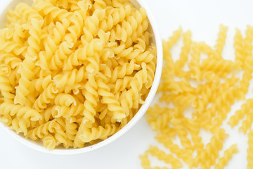 Twisted macaroni shot on a white isolated background.