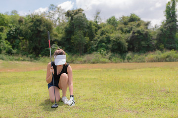 Portrait of golfer asian woman holding golf wood at the country club,Happy woman concept,Put golf...