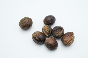 Buah pala or nutmeg shot on a white isolated background.