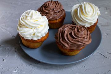 Homemade four cupcakes with caramel syrup and chocolate cream, no gluten meal