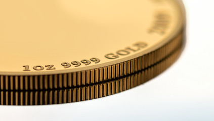 A part of a gold coin weighing 1 troy ounce. Selective focus.