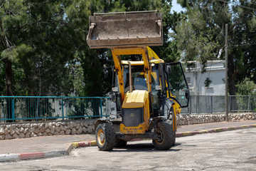 yellow excavator on a construction site, colorful decoration design with space for text. technology