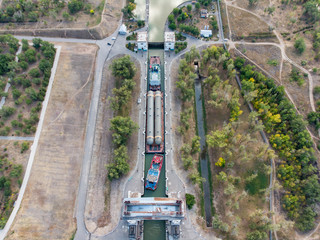 Cargo transportation of technological equipment for an oil refinery by water. freight train passes...