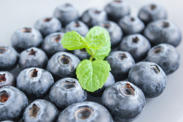 Blueberries and a leaf of fresh mint. Vitamins and antioxidants. Macro view.