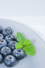 Blueberries and a leaf of fresh mint. Vitamins and antioxidants. Macro view.