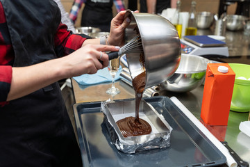 Woman pouring chocolate batter into a pan