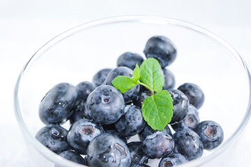Blueberries and a leaf of fresh mint. Vitamins and antioxidants. Macro view.