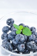 Blueberries and a leaf of fresh mint. Vitamins and antioxidants. Macro view.