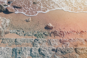 Old weathered stone steps, sand and sea. Old stone texture	