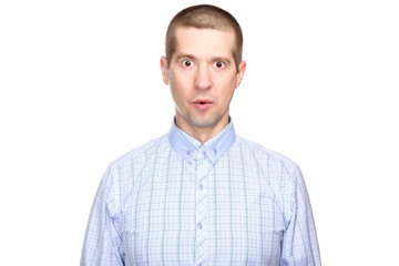 portrait of a joyful surprised man in a classic blue shirt; with eyes wide open with delight and admiration; look into the camera. Isolated