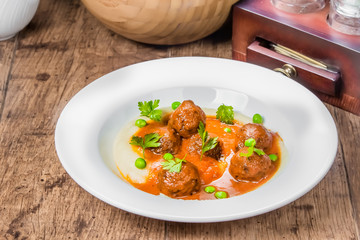 A plate of veal meatballs on a table
