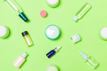 Group of plastic bodycare bottle Flat lay composition with cosmetic products on green background empty space for you design. Set of White Cosmetic containers, top view with copy space