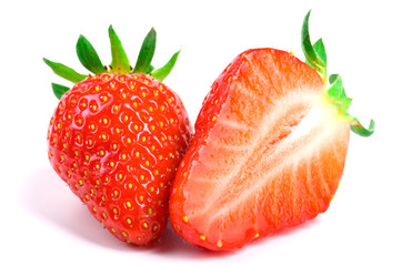 Ripe juicy red strawberries whole and sliced on a white isolated background
