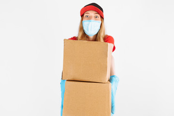 Fototapeta premium The courier is holding a cardboard box of medical rubber gloves and a mask. on white background. Fast delivery. Online stores Quarantine, coronavirus