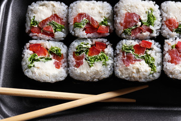Set of delicious sushi rolls. Close-up. Wooden chopsticks. Japanese food.