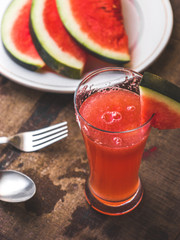 Sliced Watermelon on white plate with spoon and fork stock photo with white background.