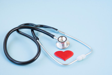 Stethoscope and red heart on a blue background. Greeting background. National doctor's day. Happy nurse 's day. Health day. Top view, a copy of the space.