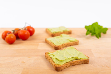 Toast with avocados and cherry tomatoes. Healthy nutrition