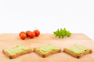 Toast with avocados and cherry tomatoes. Healthy nutrition