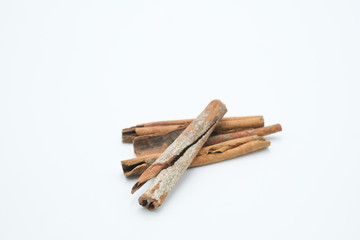 Cinnamon or Cinamon shot on a white isolated background.
