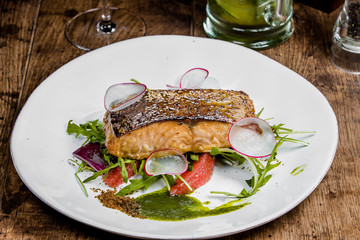 A piece of salmon steak on a white plate
