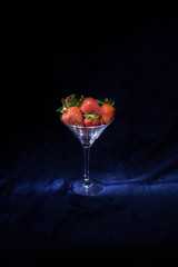 strawberries in a glass on a dark background. Silhouette style.