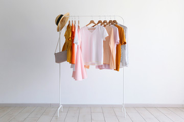 fashion clothes on a stand in a light background indoors. place for text
