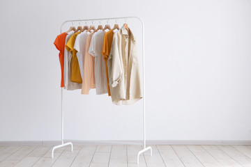 fashion clothes on a stand in a light background indoors. place for text
