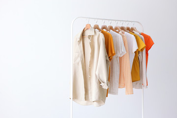 fashion clothes on a stand in a light background indoors. place for text
