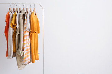 fashion clothes on a stand in a light background indoors. place for text
 - obrazy, fototapety, plakaty