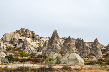 View to the exotic fairy chimney rocks formations and cave houses in Cappadocia, Turkey