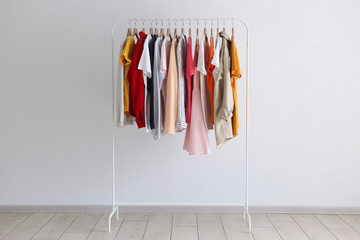 fashion clothes on a stand in a light background indoors. place for text
