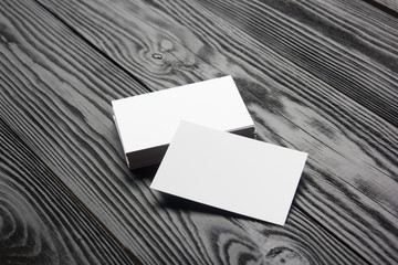 Business card blank on black wooden background. Corporate Stationery, Branding Mock-up. Creative designer desk. Flat lay. Copy space for text