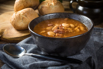 Beans with tomato sauce, bacon and sausage.