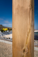 Wooden board on the vertical against the background of the beach, place for an inscription copyspace, wood texture.