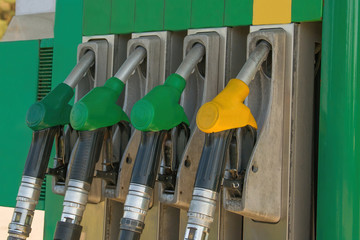 Pump nozzles at the gas fuel station. Gasoline dispenser on petrol station. Guns for refueling