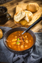 Beans with tomato sauce, bacon and sausage.