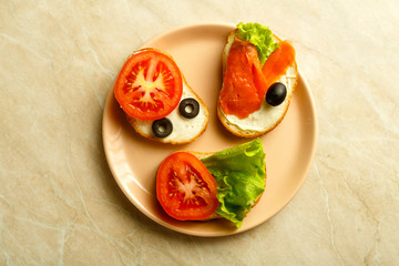 Set of assorted sandwiches on a light table on a plate.