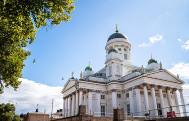 Fototapeta na wymiar Helsinki city cathedral with dome and golden crosses with back ground of cloudy blue sky, Finland