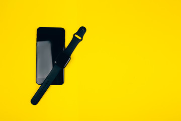 Black smart phone with black smartwatch