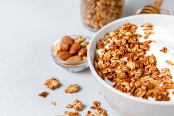 Granola and greek yogurt breakfast with honey and nuts
