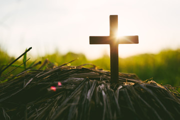 Crucifixion of Jesus christ ,cross with field at sunset.