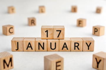 January 17 - from wooden blocks with letters, important date concept, white background random letters around