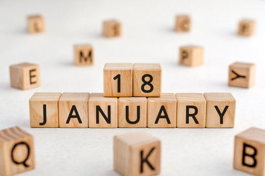 January 18 - from wooden blocks with letters, important date concept, white background random letters around